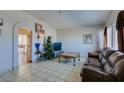 Bright living room boasts tile floors, neutral walls, and comfortable seating at 3212 Osage Ave, Las Vegas, NV 89101