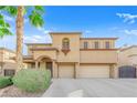 Inviting two-story home featuring an arched entry, desert landscaping and a two-car garage at 3213 Salutare Ct, North Las Vegas, NV 89031