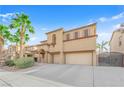 Two-story home featuring a barrel tile roof, desert landscaping, and a two-car garage at 3213 Salutare Ct, North Las Vegas, NV 89031