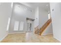 Bright foyer with double door entry, high ceilings, and staircase at 3504 Frigatebird Ln, North Las Vegas, NV 89084