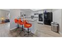 A kitchen with granite countertops, white cabinets and sleek, black appliances at 3630 Mckinley Ave, Las Vegas, NV 89121