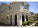 Charming home featuring stucco walls, blue shutters, and a unique arched front porch design at 3732 Via Gennaro, Henderson, NV 89044
