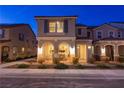 Inviting home exterior at dusk, showcasing the arched porch with ambient lighting at 3732 Via Gennaro, Henderson, NV 89044