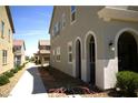 Stunning home exterior with stucco walls, blue shutters, and unique architectural details at 3732 Via Gennaro, Henderson, NV 89044