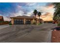 Large driveway leading to a well-maintained home with a spacious multi-car garage at 402 E Country Club Dr, Henderson, NV 89015