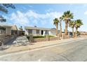 View of single-story home featuring a driveway and lush lawn at 436 Bell Ave, Henderson, NV 89015