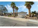 Single-story home featuring a two car garage and mature landscaping at 436 Bell Ave, Henderson, NV 89015