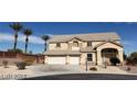 Two-story home with a three-car garage and desert landscaping under a clear blue sky at 4798 Luna Ridge Ct, Las Vegas, NV 89129