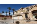 Two-story home with a three-car garage and desert landscaping under a clear blue sky at 4798 Luna Ridge Ct, Las Vegas, NV 89129