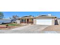 Charming single-story home featuring a well-maintained lawn and two-car garage at 524 8Th St, Boulder City, NV 89005