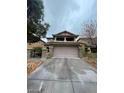 Home featuring a two-car garage, stone accents, and a covered porch at 5413 Bristol Bend Ct, Las Vegas, NV 89135