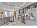 Modern kitchen featuring stainless steel appliances, sleek countertops, and wood-look flooring for a stylish cooking space at 5841 Doubletree Rd, Pahrump, NV 89061
