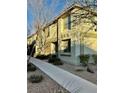 Well-maintained townhomes with neutral exteriors, surrounded by tidy landscaping at 6145 Scarlet Leaf St, Las Vegas, NV 89148