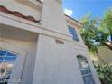 Close up of home's facade showing address number, windows, and textured exterior at 7963 Laurena Ave, Las Vegas, NV 89147