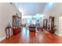Spacious living room with hardwood floors, a fireplace, and elegant decor creating an inviting atmosphere at 8169 Pinnacle Peak Ave, Las Vegas, NV 89113