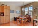The spacious dining room features wood floors, a large window, and chandelier at 9413 Ironsend St, Las Vegas, NV 89143
