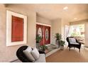Elegant covered entryway with double doors, shuttered window and patio furniture at 1332 Cedar Berry Ct, Henderson, NV 89012