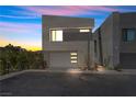 Modern exterior with a stucco siding and a two-car garage at 14 Heron Harbour Dr, Henderson, NV 89011