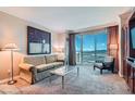 Inviting living room with comfortable seating and expansive city view windows at 145 E Harmon Ave # 2008, Las Vegas, NV 89109