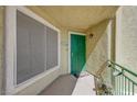 A welcoming entrance features a vibrant green door and a secure screen window at 1509 Linnbaker Ln # 203, Las Vegas, NV 89110