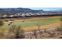 Scenic view of the golf course with mountain views and houses in the background on a sunny day at 21 Via Visione # 201, Henderson, NV 89011