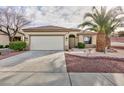 Charming single-story home with well-maintained landscaping and a spacious driveway at 2125 Desert Woods Dr, Henderson, NV 89012