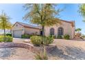 Lovely home featuring desert landscaping, two arched windows, and a brick-lined garden at 2253 Laurel Heights Ln, Henderson, NV 89052