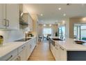 Modern kitchen with stainless steel appliances, quartz countertops, and bright, open layout at 24 Cliffwater St, Henderson, NV 89011