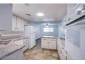 Eat in kitchen with granite countertops, white cabinets, and stainless steel appliances at 26 Jade Circle Cir, Las Vegas, NV 89106