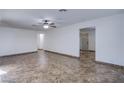 Open living room with tile floors, neutral walls, and modern ceiling fan at 26 Jade Circle Cir, Las Vegas, NV 89106