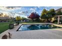 An inviting backyard pool on a sunny day, featuring well-maintained landscaping and hardscape, offering a serene retreat at 281 Deerleap Cir, Henderson, NV 89052