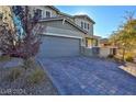 Beautiful exterior of home featuring brick driveway and well maintained yard at 2832 Aragon Terrace Way, Henderson, NV 89044