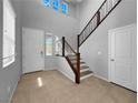 Bright foyer featuring tile flooring, staircase, and an open layout at 2832 Aragon Terrace Way, Henderson, NV 89044