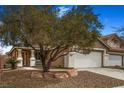 Charming single-story home featuring desert landscaping, and a two-car garage at 3208 Paragon Pointe St, Las Vegas, NV 89129