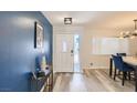 Bright foyer featuring stylish blue accent wall, modern light fixture, and an inviting white front door at 3543 Algonquin Dr, Las Vegas, NV 89169