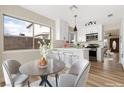 Eat-in kitchen featuring a breakfast bar, stainless appliances, and bright white cabinets at 3853 Kellogg Ave, Las Vegas, NV 89115