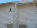 Exterior shot of a two story condo with a light colored facade and dark unit numbers at 4770 Topaz St # 31, Las Vegas, NV 89121