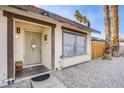 Close up of front door with rock landscaping and neutral paint at 5399 Surrey St, Las Vegas, NV 89119