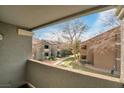 Scenic balcony view overlooking a grassy courtyard with mature trees and building exteriors at 555 E Silverado Ranch Blvd # 2033, Las Vegas, NV 89183