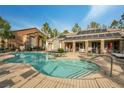 Resort-style community pool area with solar panels, lounge chairs, and umbrellas at 555 E Silverado Ranch Blvd # 2033, Las Vegas, NV 89183