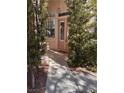 Charming front entrance framed by trees, with a glass-paneled door and stylish outdoor lighting at 5748 Spring Ranch Pkwy, Las Vegas, NV 89118