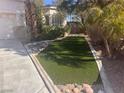 Inviting front yard with manicured artificial turf and decorative rock borders for low maintenance at 5748 Spring Ranch Pkwy, Las Vegas, NV 89118