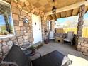 Comfortable front porch with a stone facade, seating, and decorative accents at 628 Avenue L, Boulder City, NV 89005