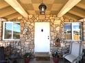 Inviting front porch featuring a stone facade and seating area at 628 Avenue L, Boulder City, NV 89005