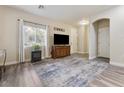 Living room with hard surface floors, neutral paint, a window, and an archway at 6317 Beige Bluff St # 3, North Las Vegas, NV 89081