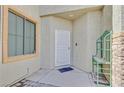 Close up view of the front door entrance of this home, with a security screen door and modern door bell at 6329 Aloha Sue St, North Las Vegas, NV 89031