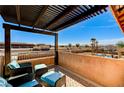 Cozy balcony with comfortable seating offering views of the surrounding neighborhood and clear blue sky at 6689 Sparks Ave, Las Vegas, NV 89142