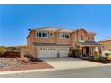 Spacious two-story house with a three-car garage, desert-style front yard, and covered porch at 6689 Sparks Ave, Las Vegas, NV 89142