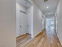 Bright hallway featuring wood-look floors and modern white doors at 697 Sunray Park St, Henderson, NV 89011