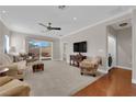 Comfortable living room features neutral carpet, sliding glass door, and ceiling fan at 7633 Lily Trotter St, North Las Vegas, NV 89084